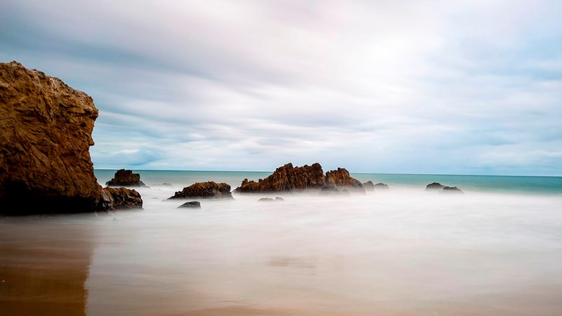 Leo Carrillo Beach Rocks emerging from ocean.