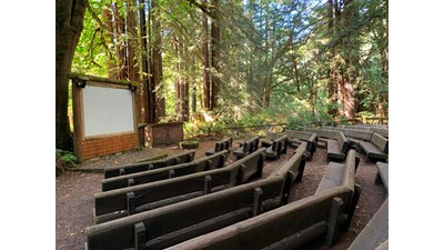 Wooden benches in front of a an outdoor screen