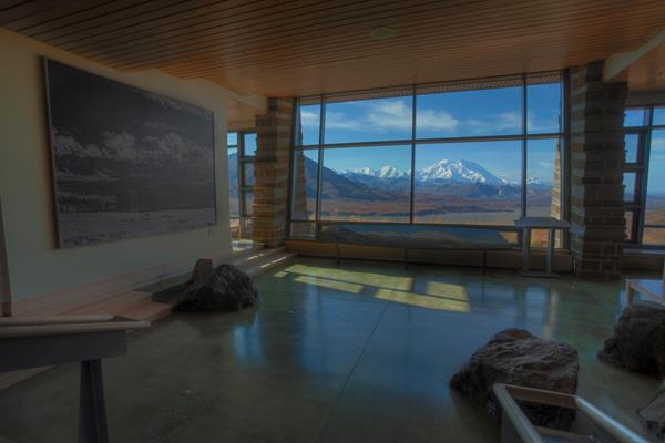 large picture window in a visitor center looking out at mountain scenery