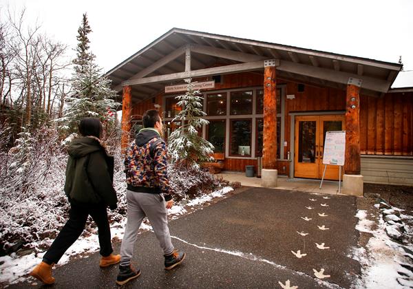 two people walking toward a building