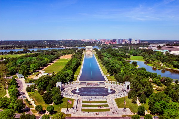 Aerial view of stone columns around an oval-shaped pool at the World War II Memorial.