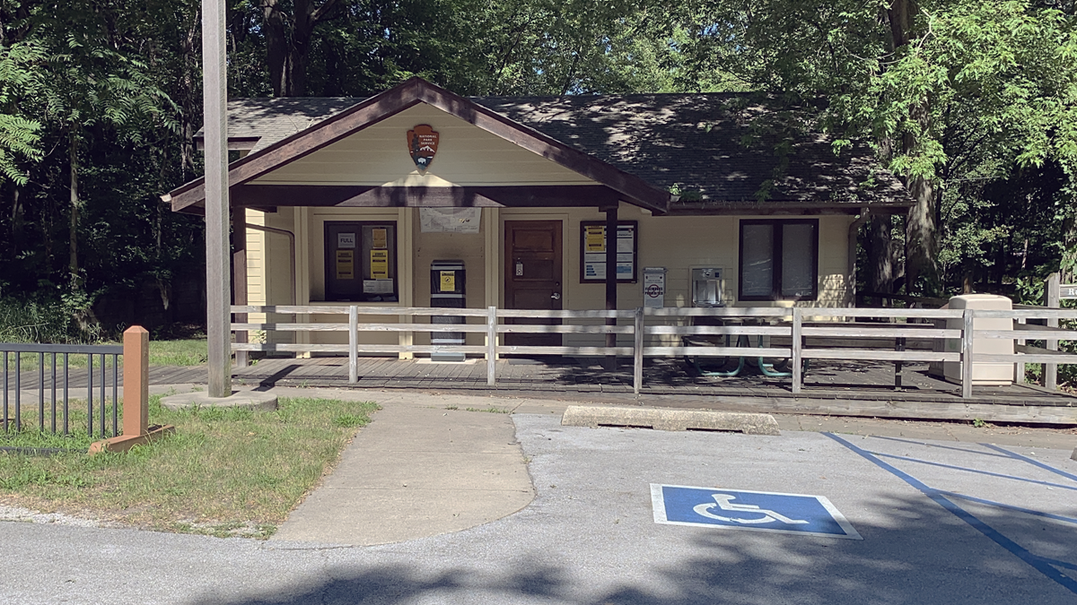 The Dunewood Campground check-in building surrounded by trees.