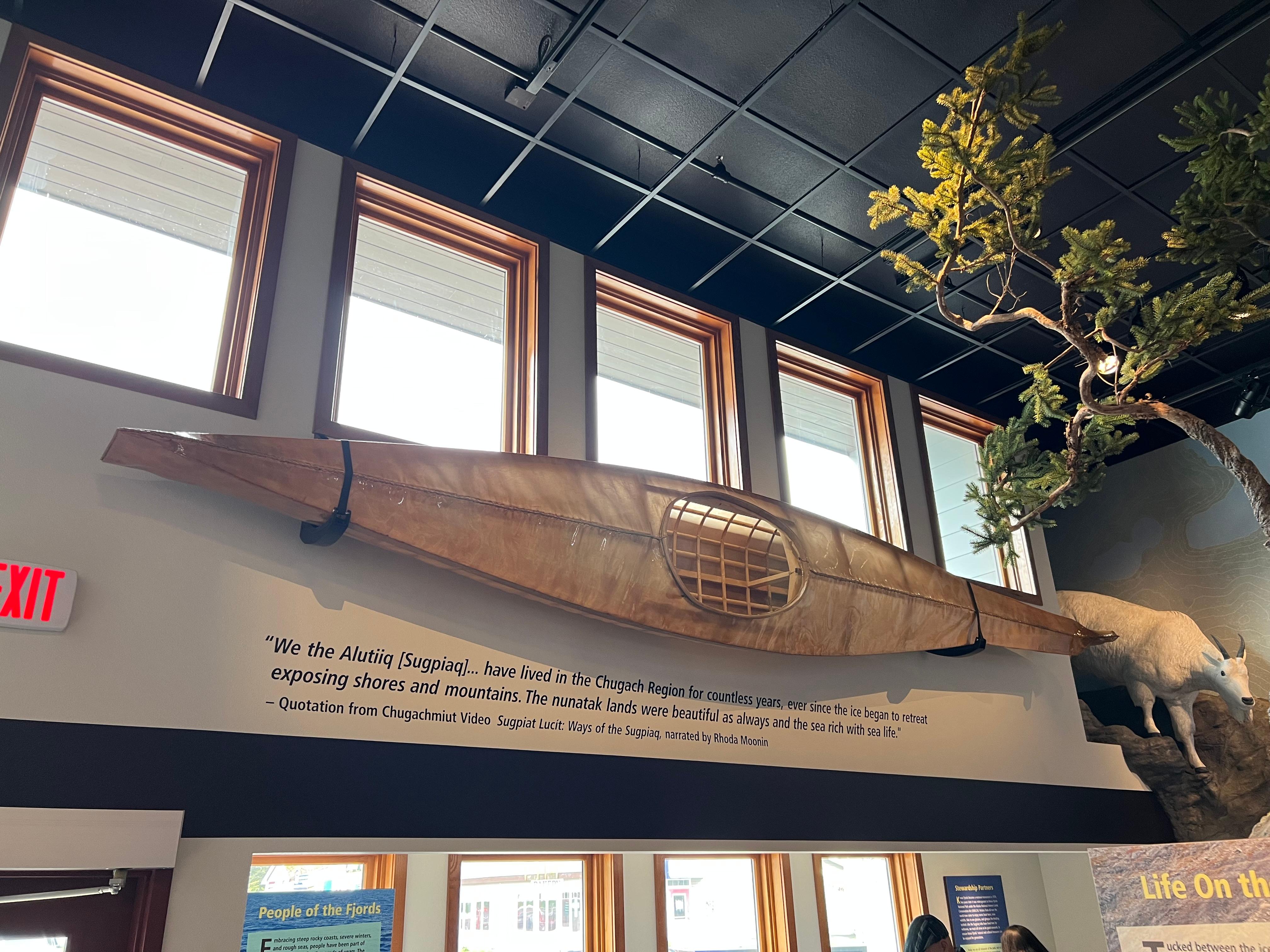 A traditional Sugpiaq qayaq (kayak) displayed on a wall.