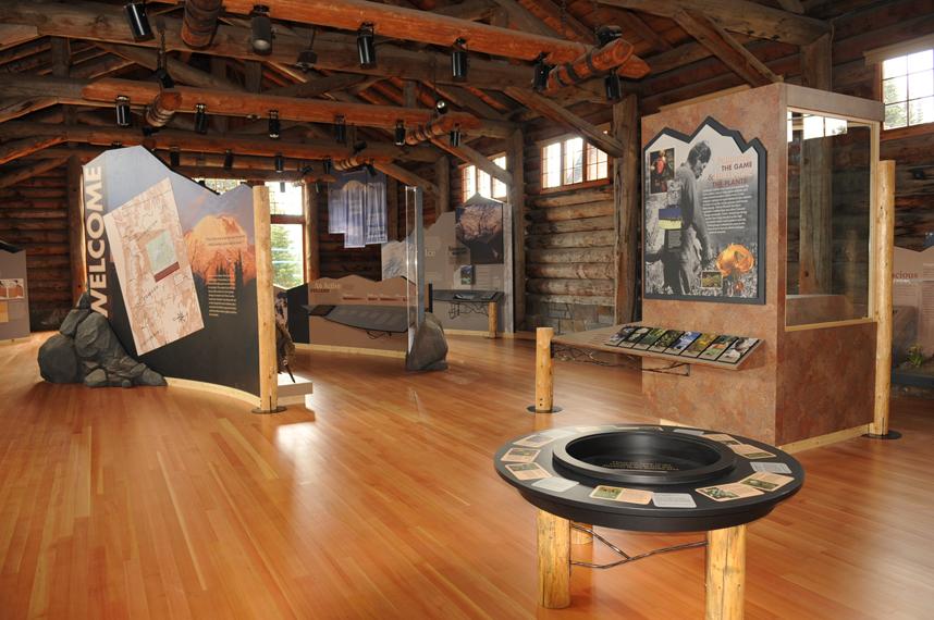 Log beams and exhibits that evoke natural material inside the Sunrise Visitor Center.