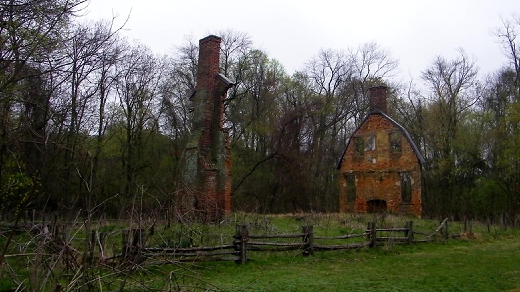 Ruins of a brick chimney and wall.