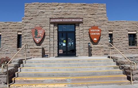 Front of Rainbow Forest Museum, built of sandstone blocks with stairs leading up, under a blue sky.