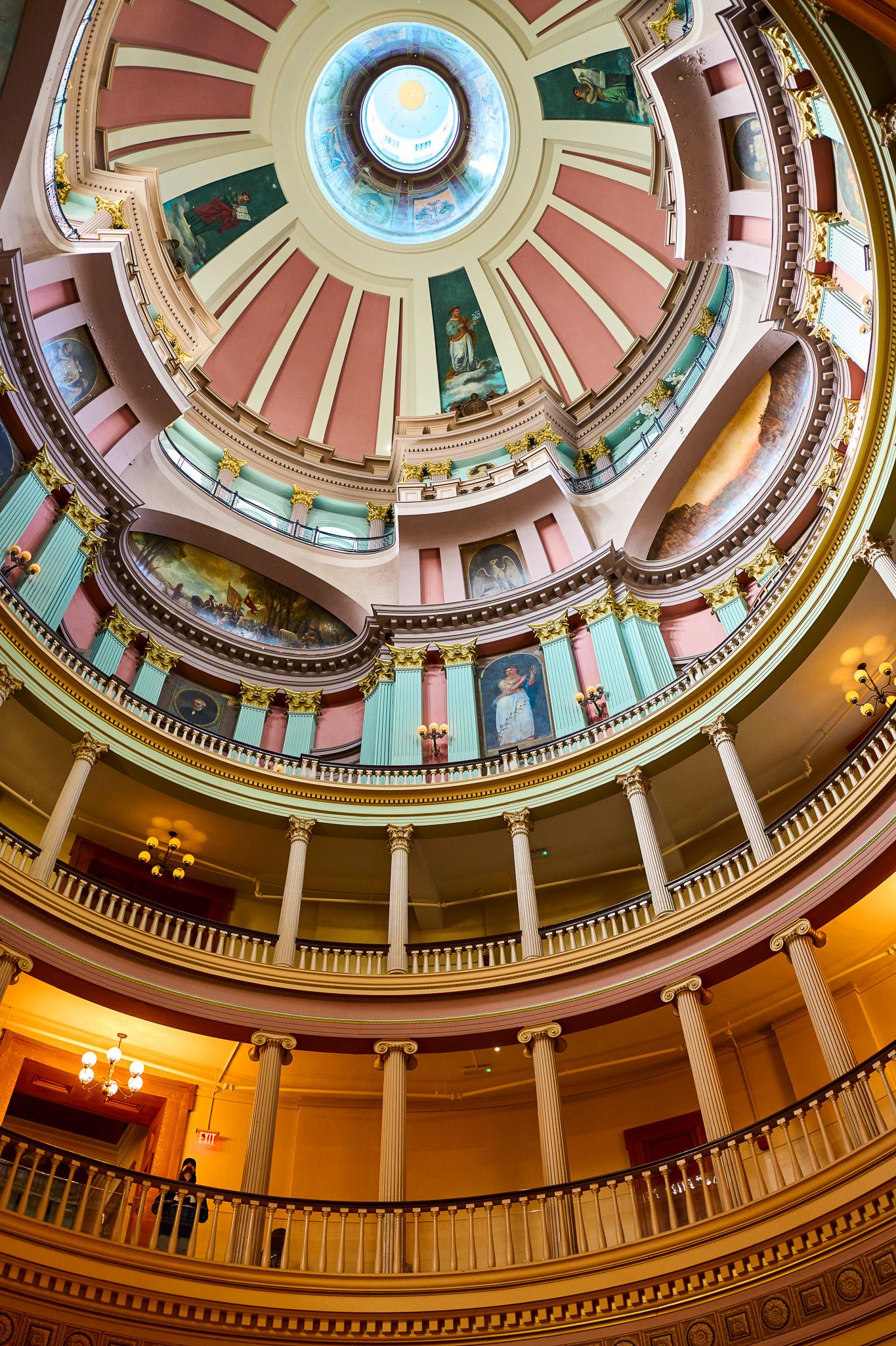 A colorful view of the artwork frescos on the ceiling of the old courthouse