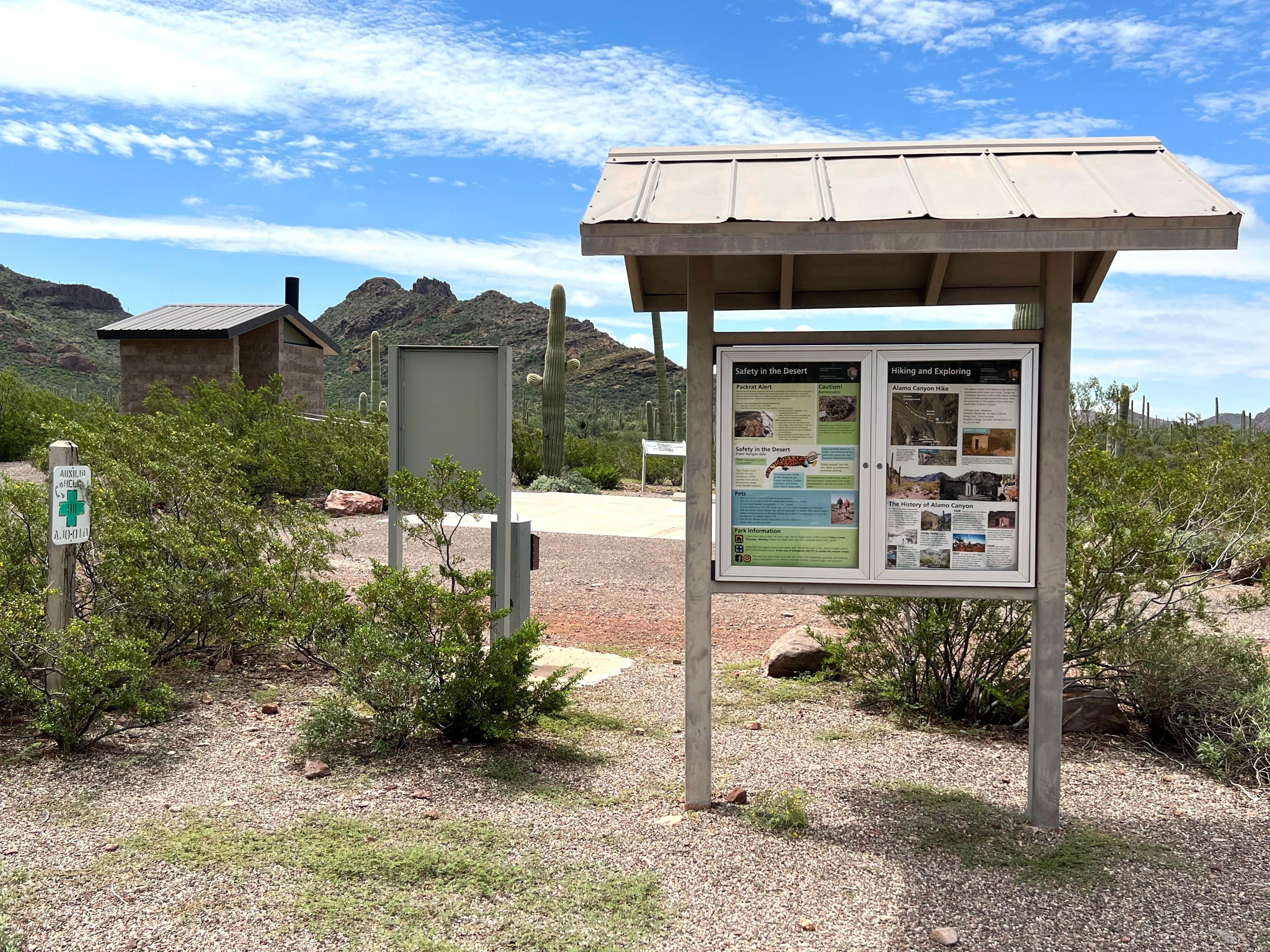 The Alamo Canyon information sign is located near the vault toilet.