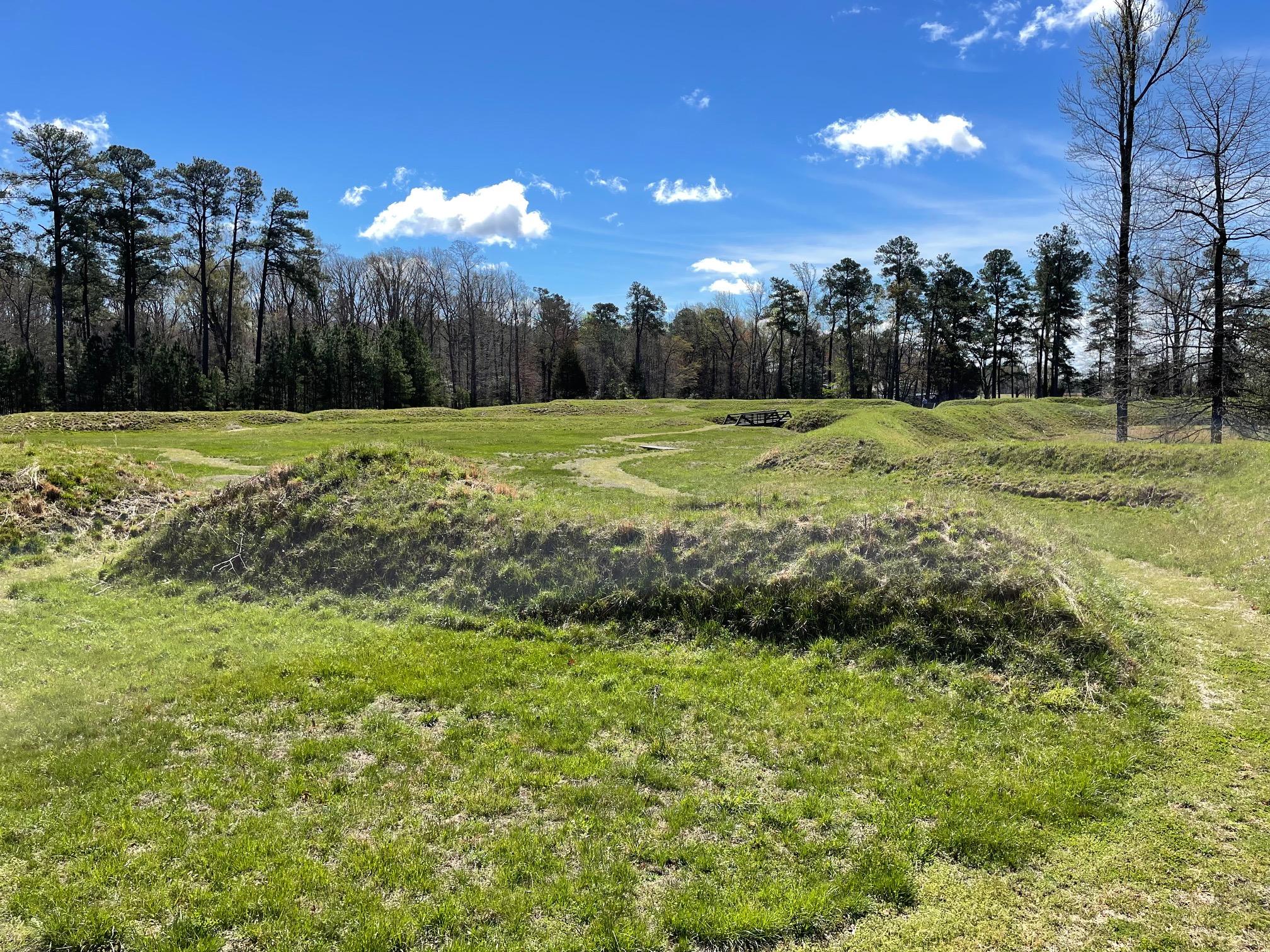 Earthworks covered in green grass.