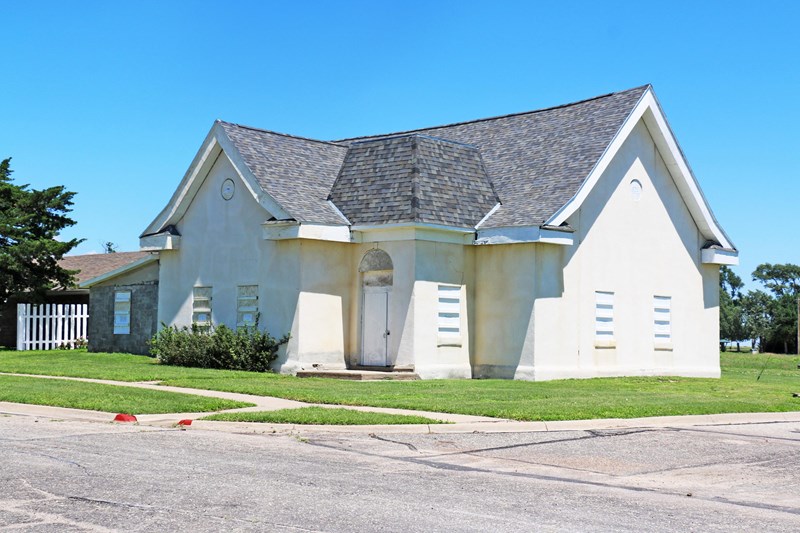Old First Baptist Church A limestone stucco building on a street corner