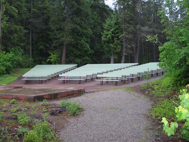 two aisles run through green benches that point to platform