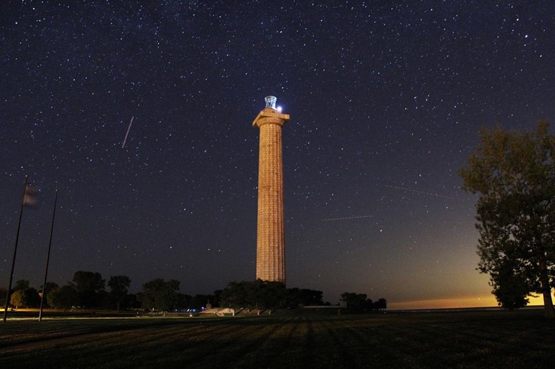 Night Sky and Memorial Night sky with Memorial Column in the middle with sun just starting to come up in lower right corner