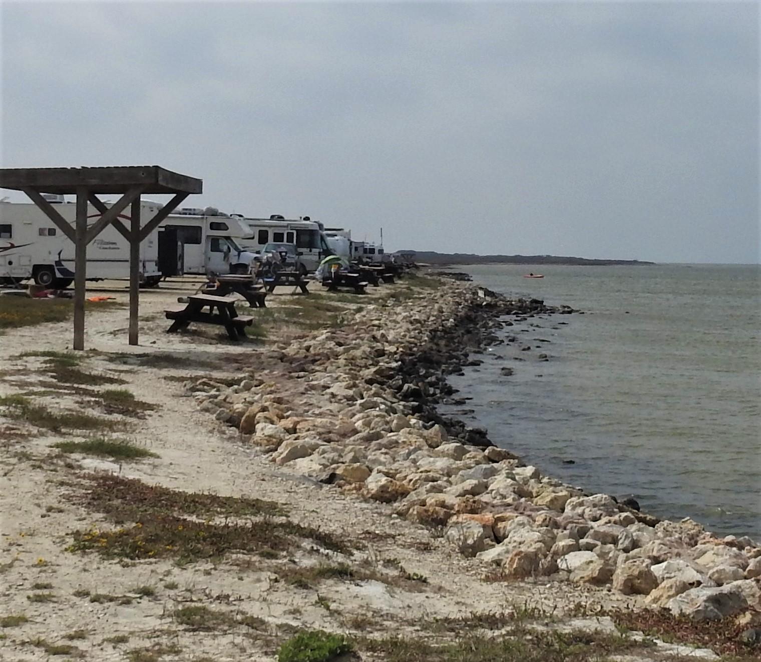 camping vehicles in side by side sites facing Laguna Madre