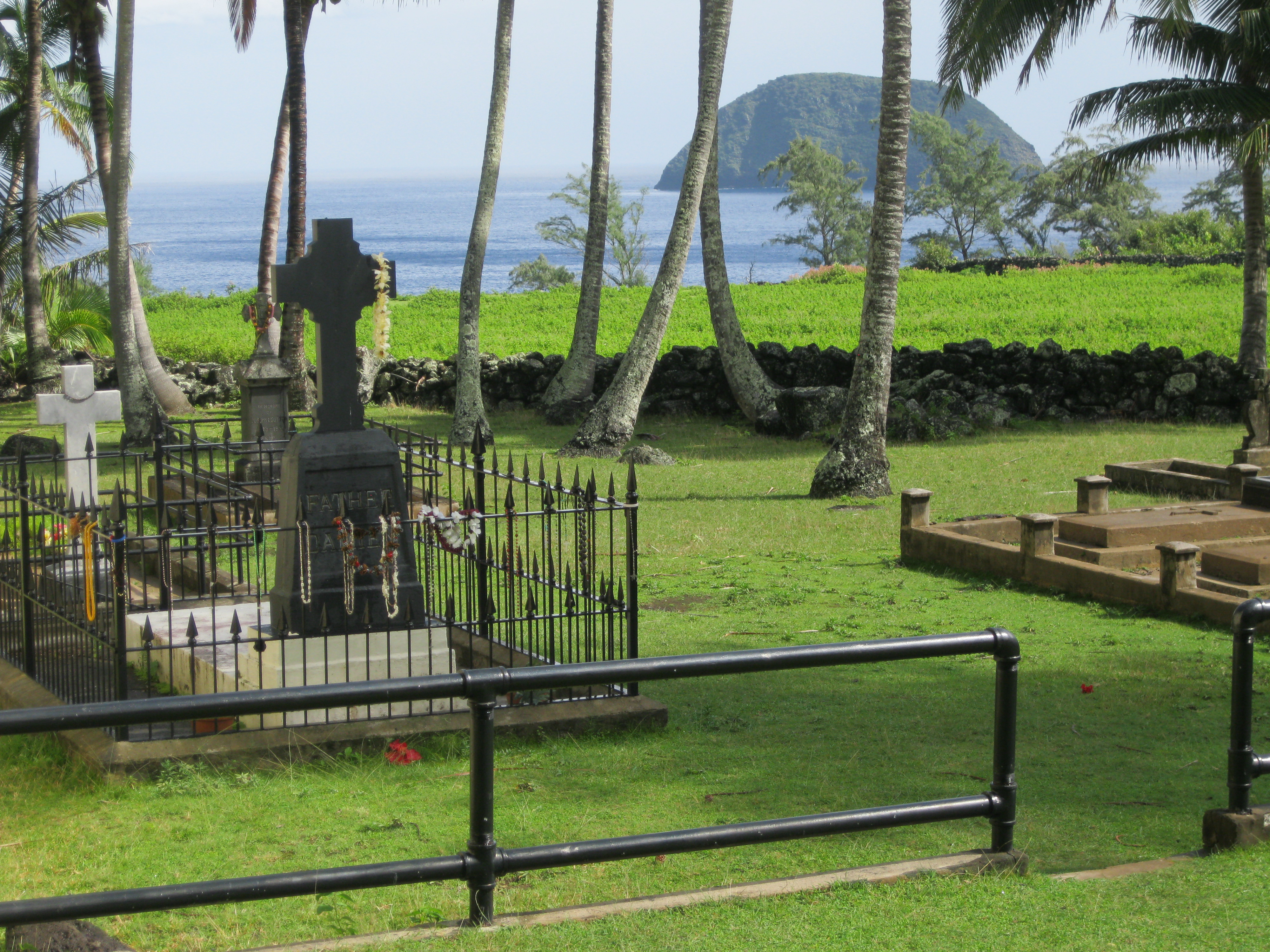 View of St. Damien's Grave at Kalawao with ocean in background.