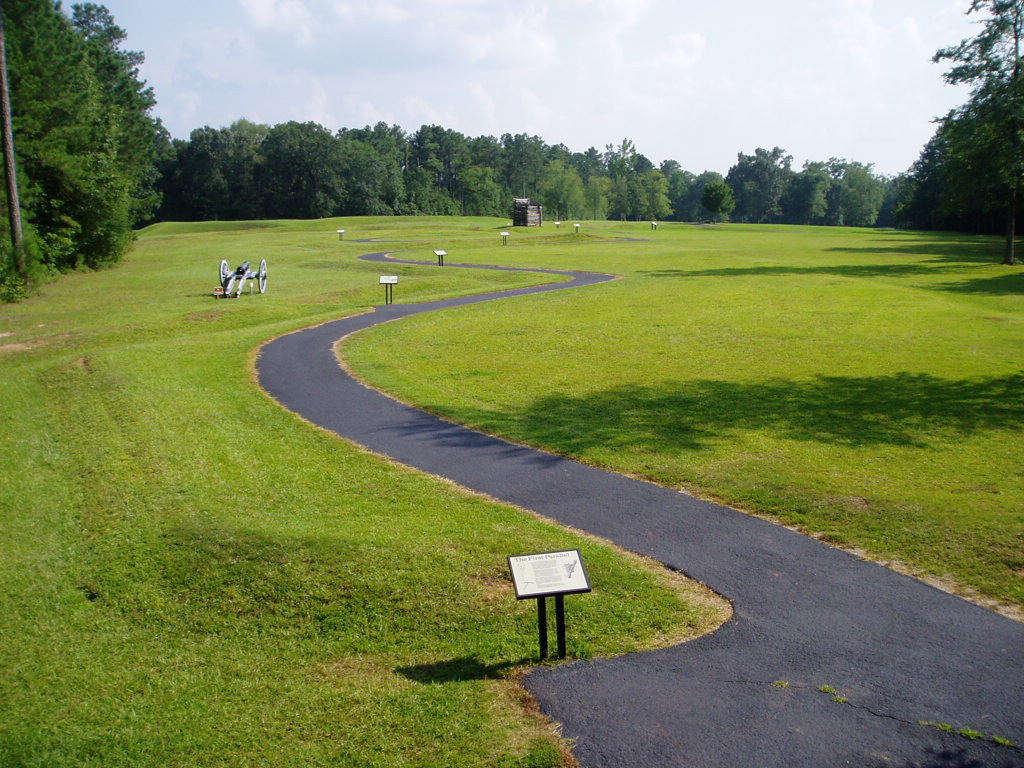 The walking trail winds past a cannon and a rifle tower.