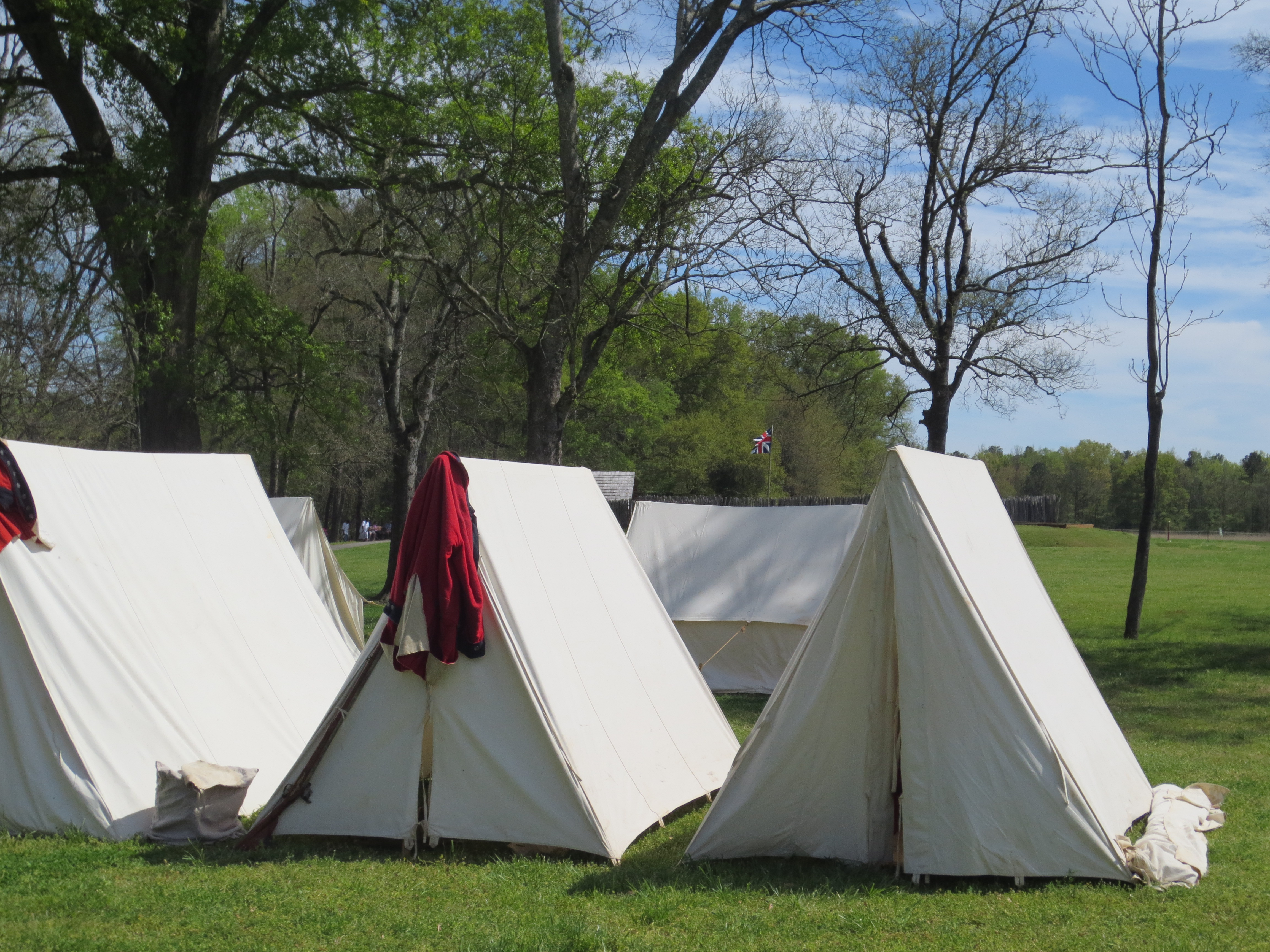 A British regimental coat hangs on a tent.