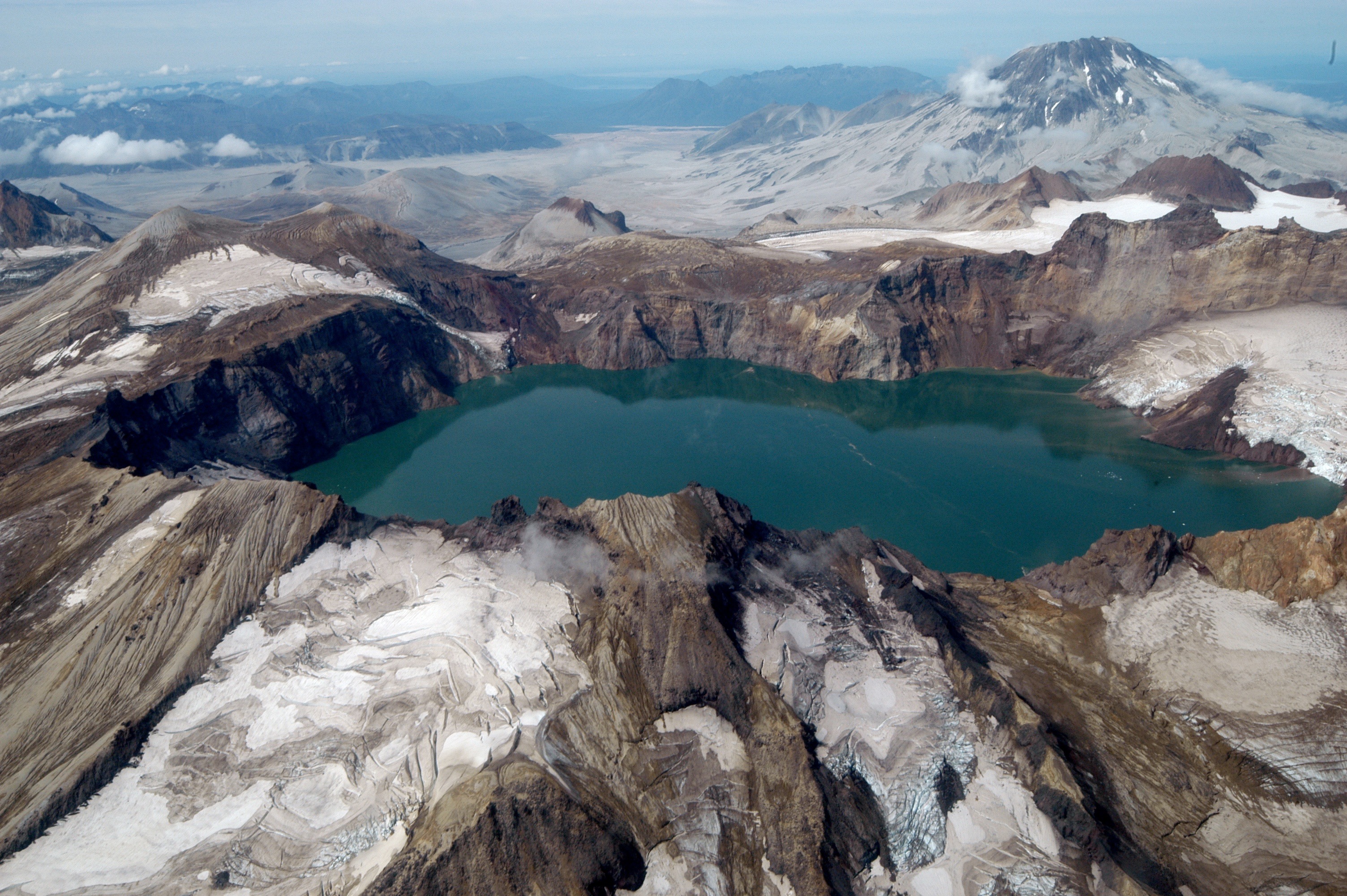 lake inside of an ash and glacier covered volcano