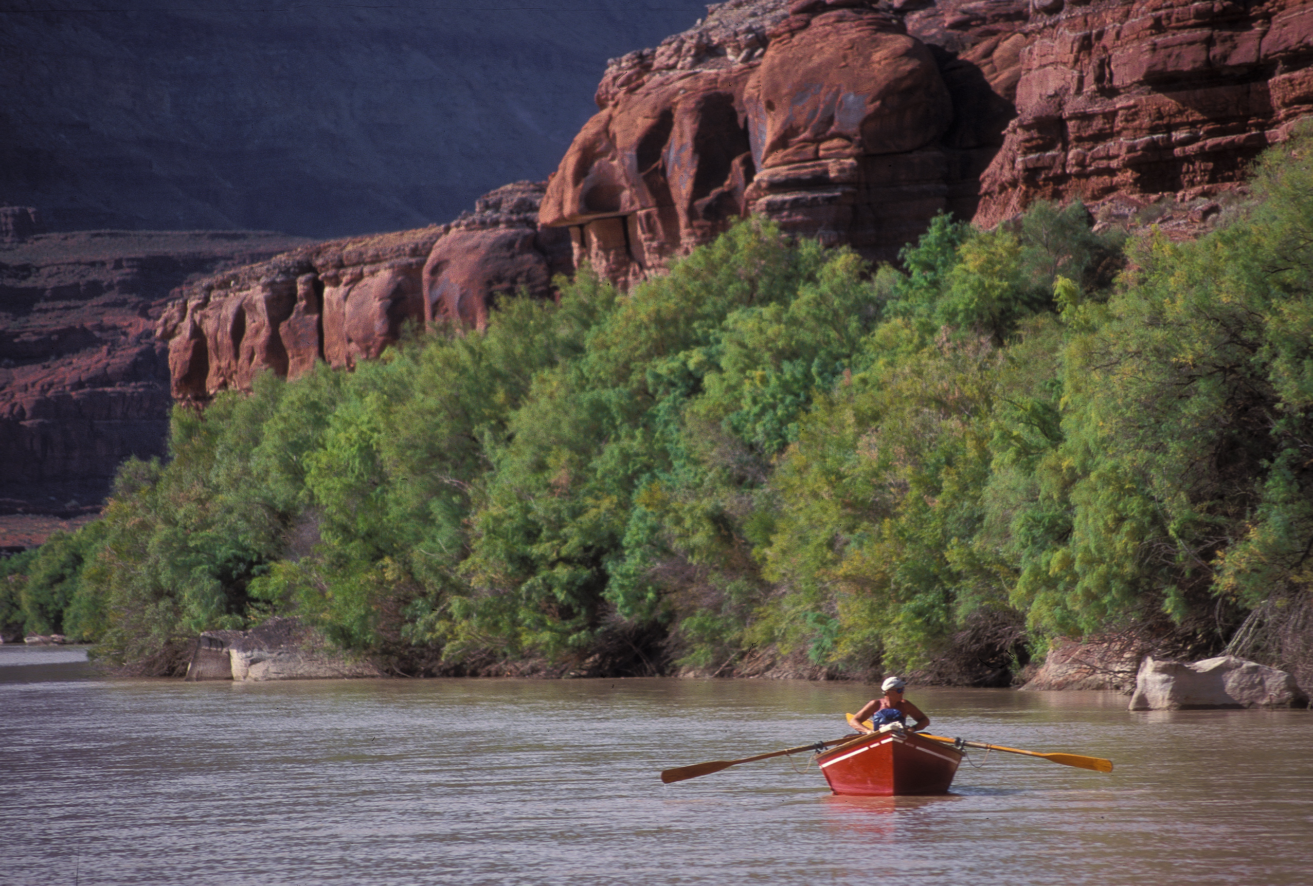 a person rowing a dory on the Colorado River