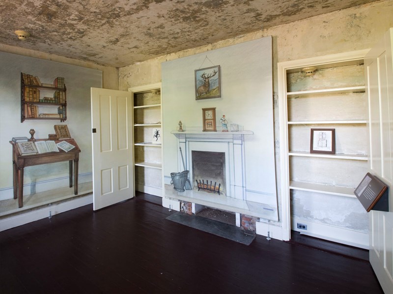 Parlor Color photo of the parlor in the Poe House showing illustrations of furniture on the walls.