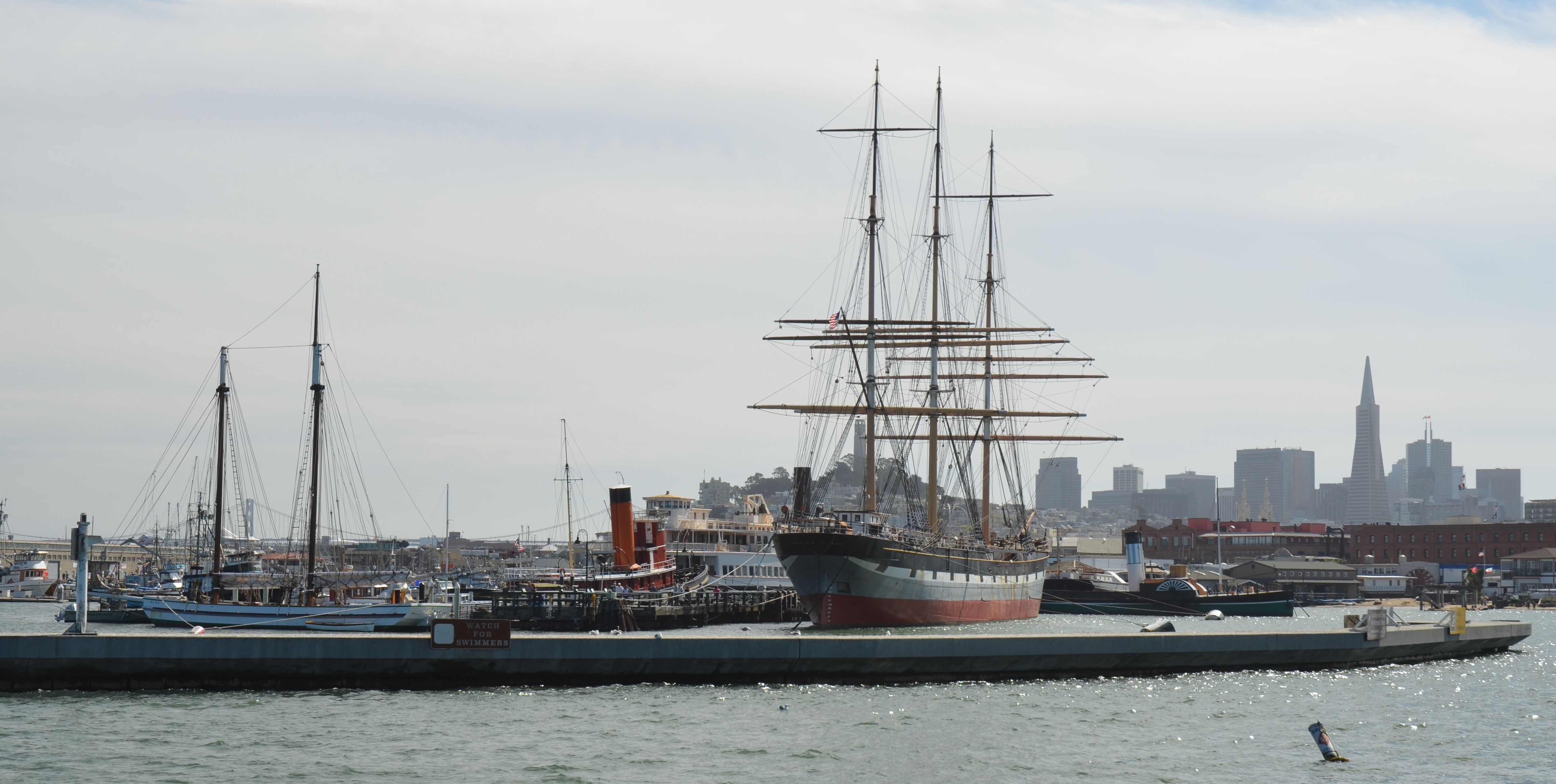 A group of vessels moored at at pier.