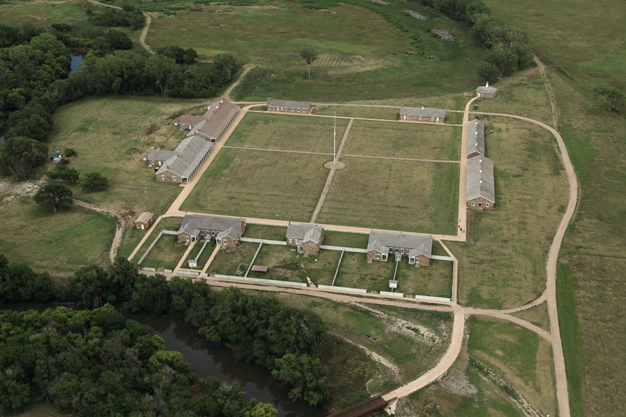 Sandstone army buildings arranged in a square around parade ground.