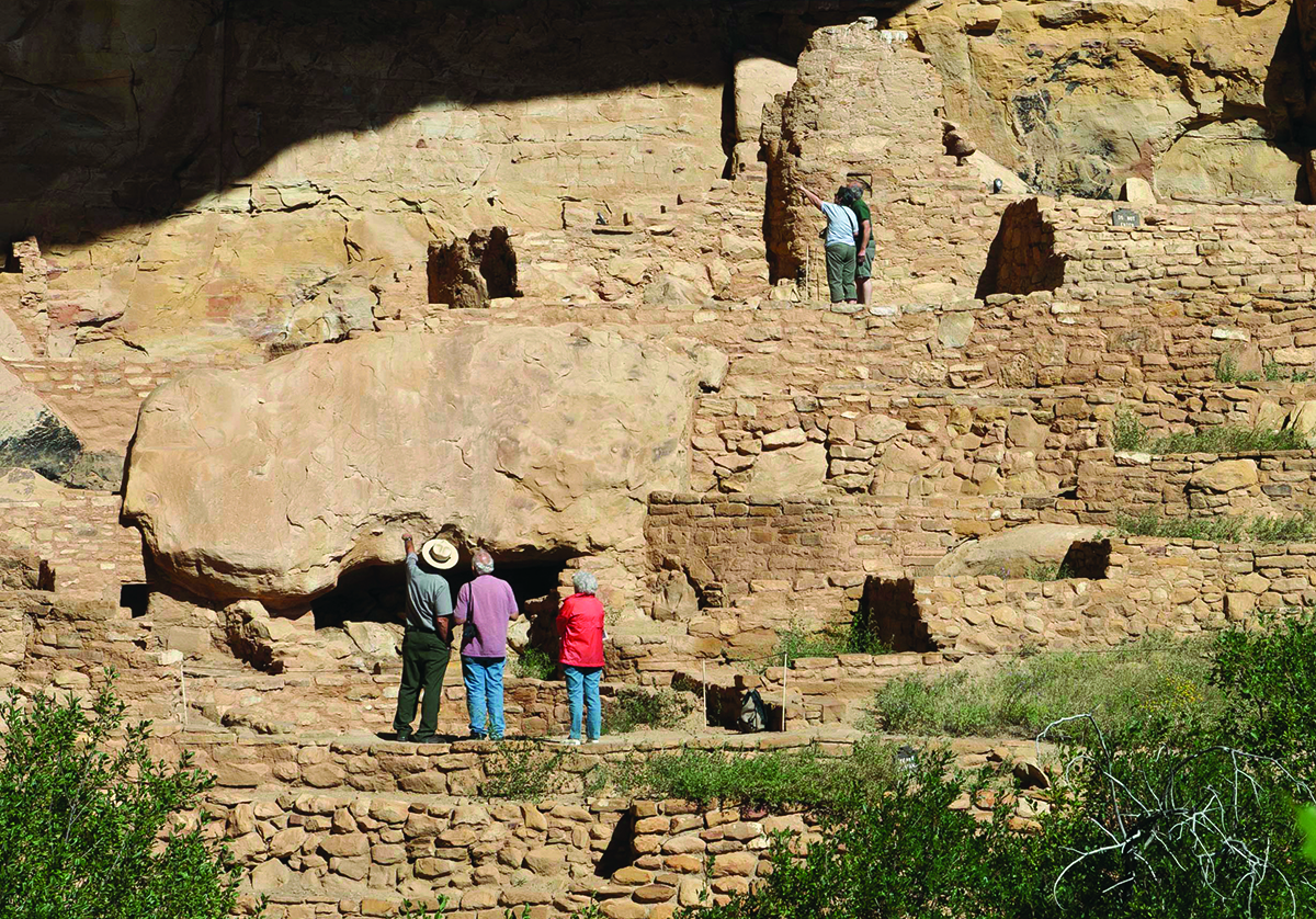 Park visitors visiting a cliff dwelling