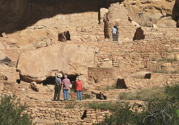 Park visitors visiting a cliff dwelling