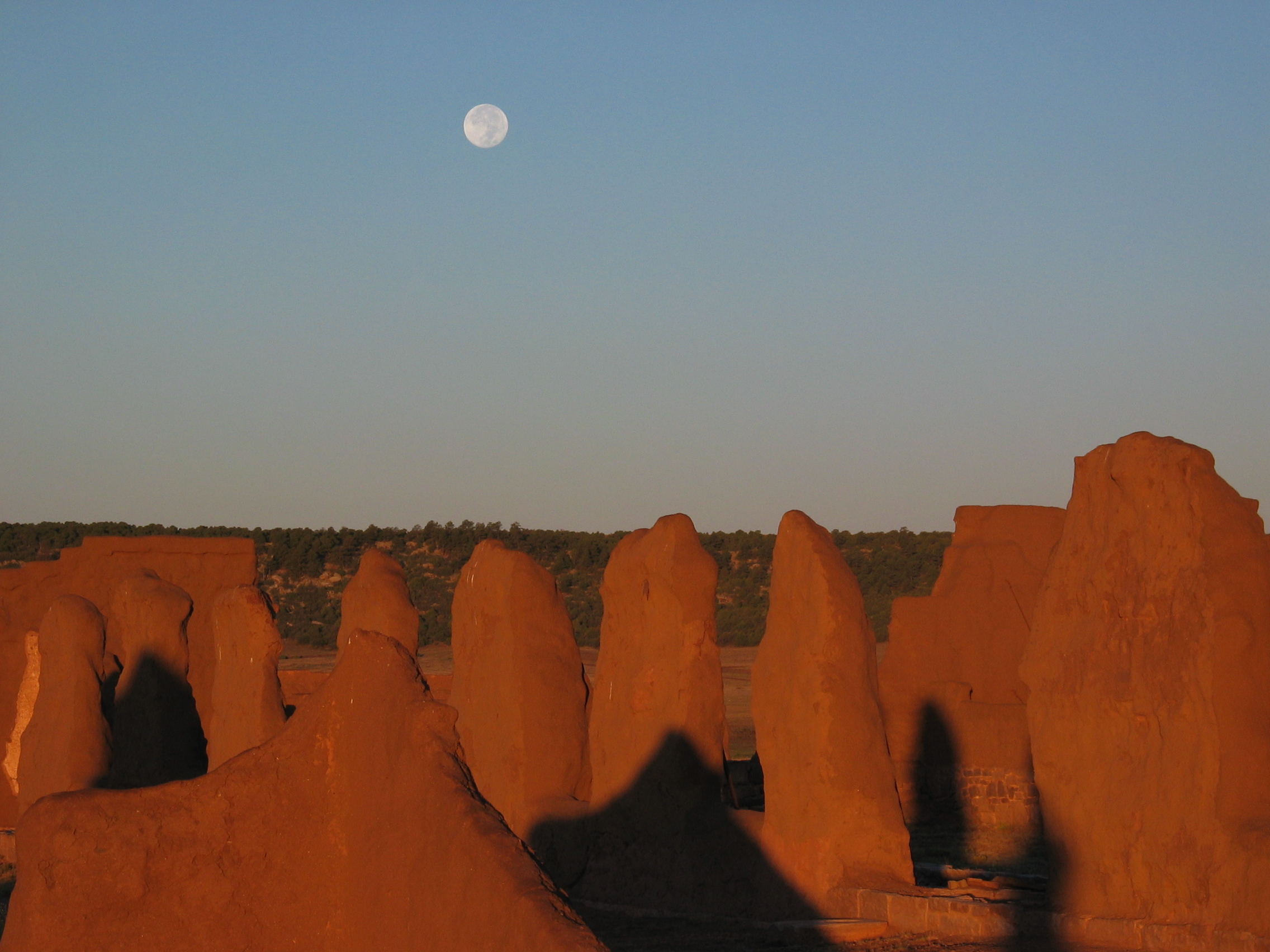 Moon in sky above adobe remnants