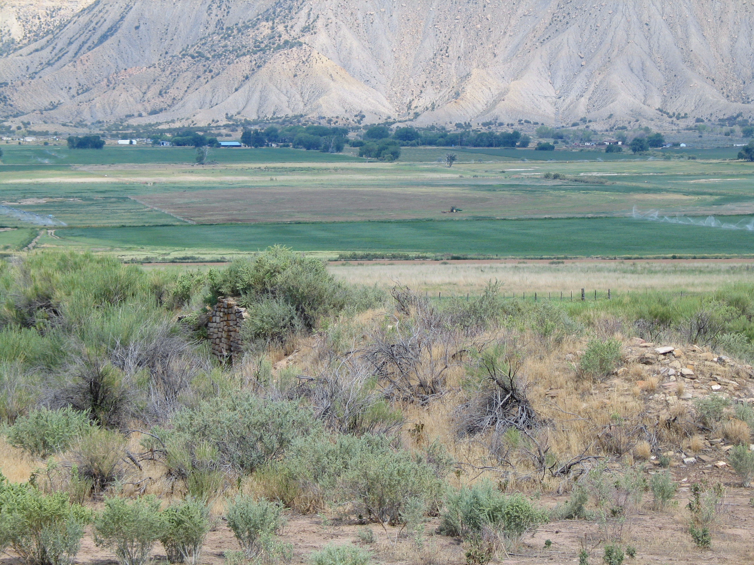 View of ancient wall in the center of agricultural land surrounding it.
