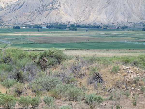 View of  ancient wall in the center of agricultural land surrounding it.