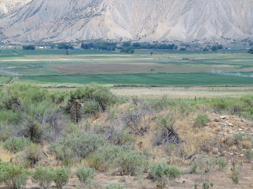 View of  ancient wall in the center of agricultural land surrounding it.