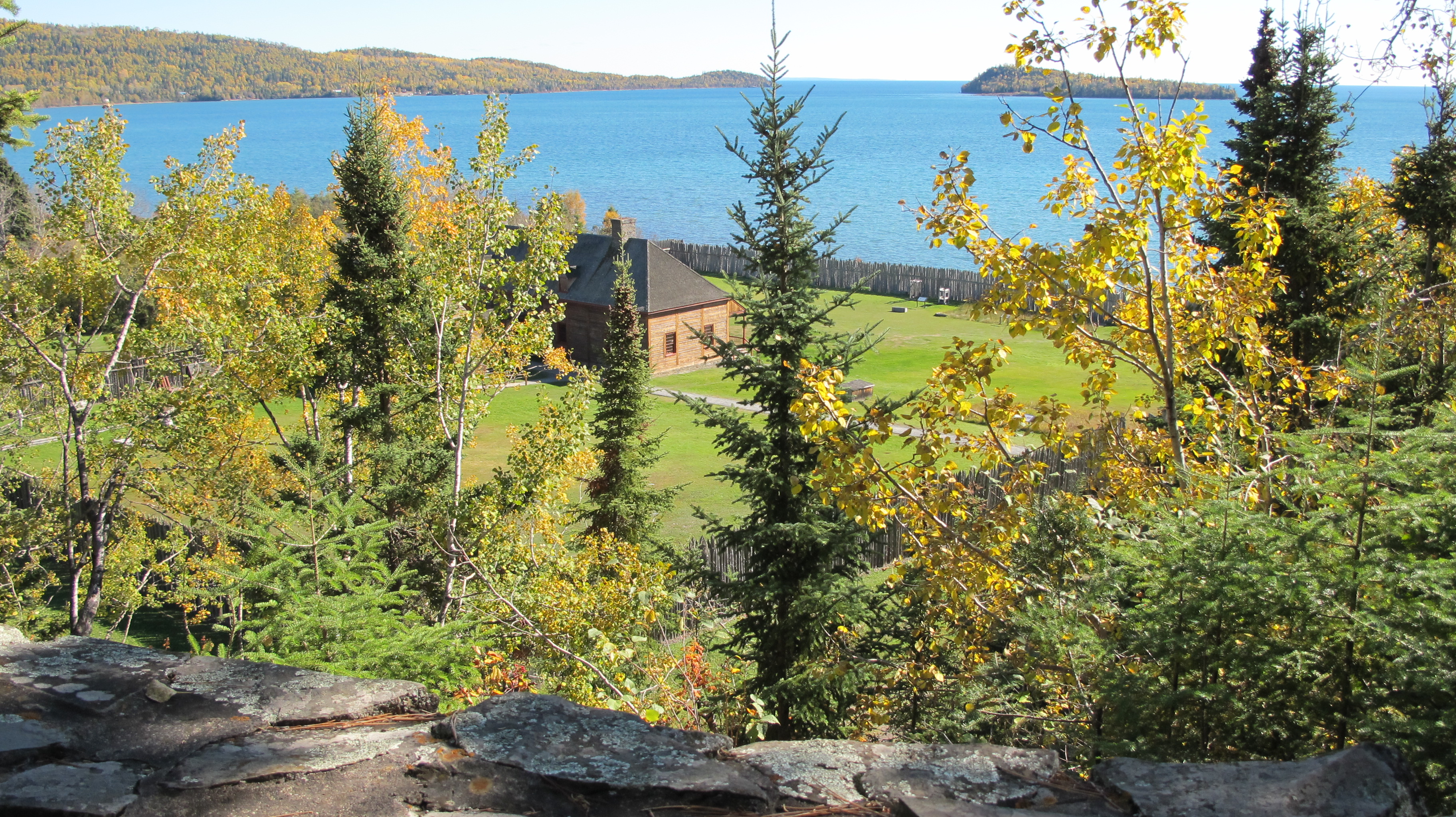 Stockade fence and log building overlooking Lake Superior