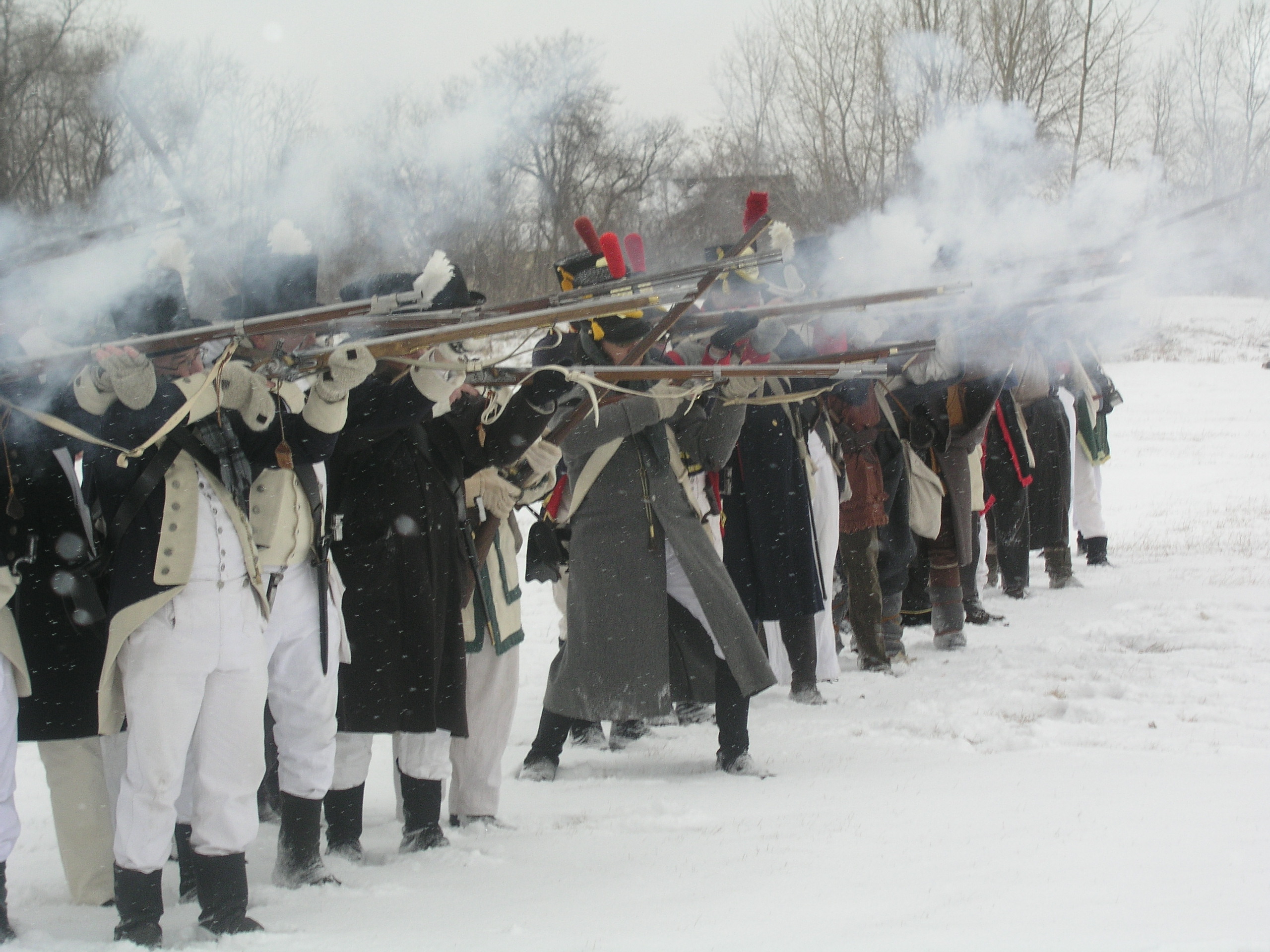 re-enactors firing in a battle line