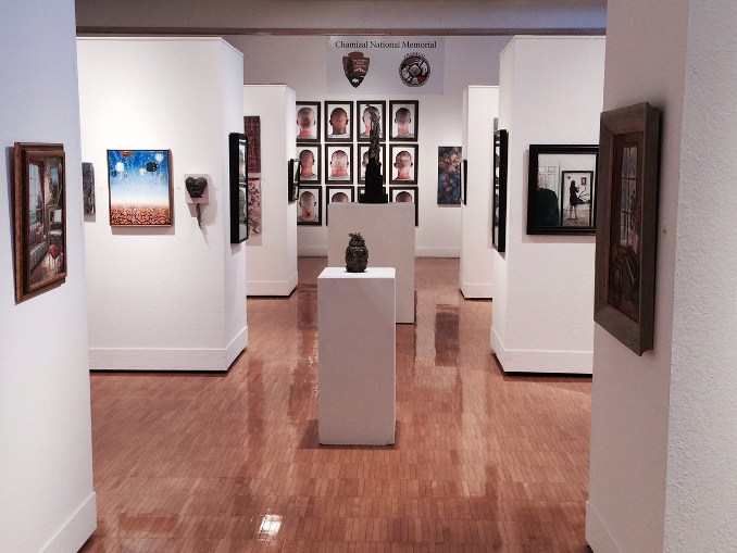 paintings hang from art gallery walls