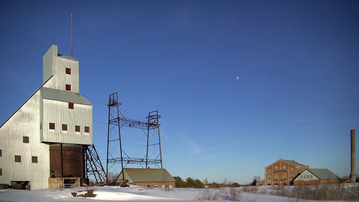 140 foot tall industrial building with a steeply pitched roofline under blue skies and snowy ground 