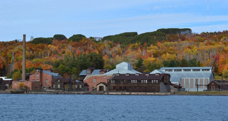 Quincy Mining Company Smelter With a colorful autumn background, numerous industrial buildings sit on the waterfront
