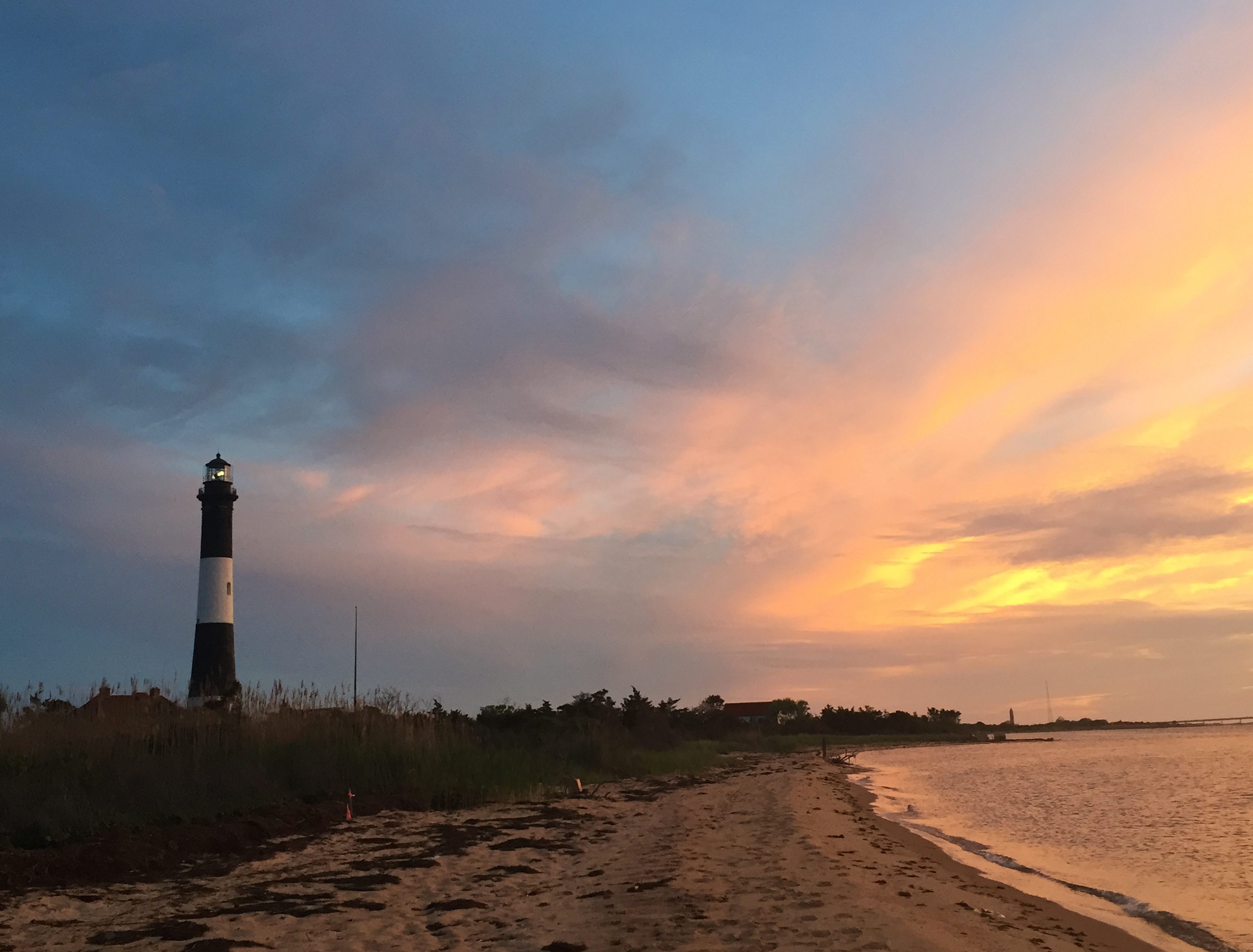 The Fire Island Lighthouse against a vibrant sunset.