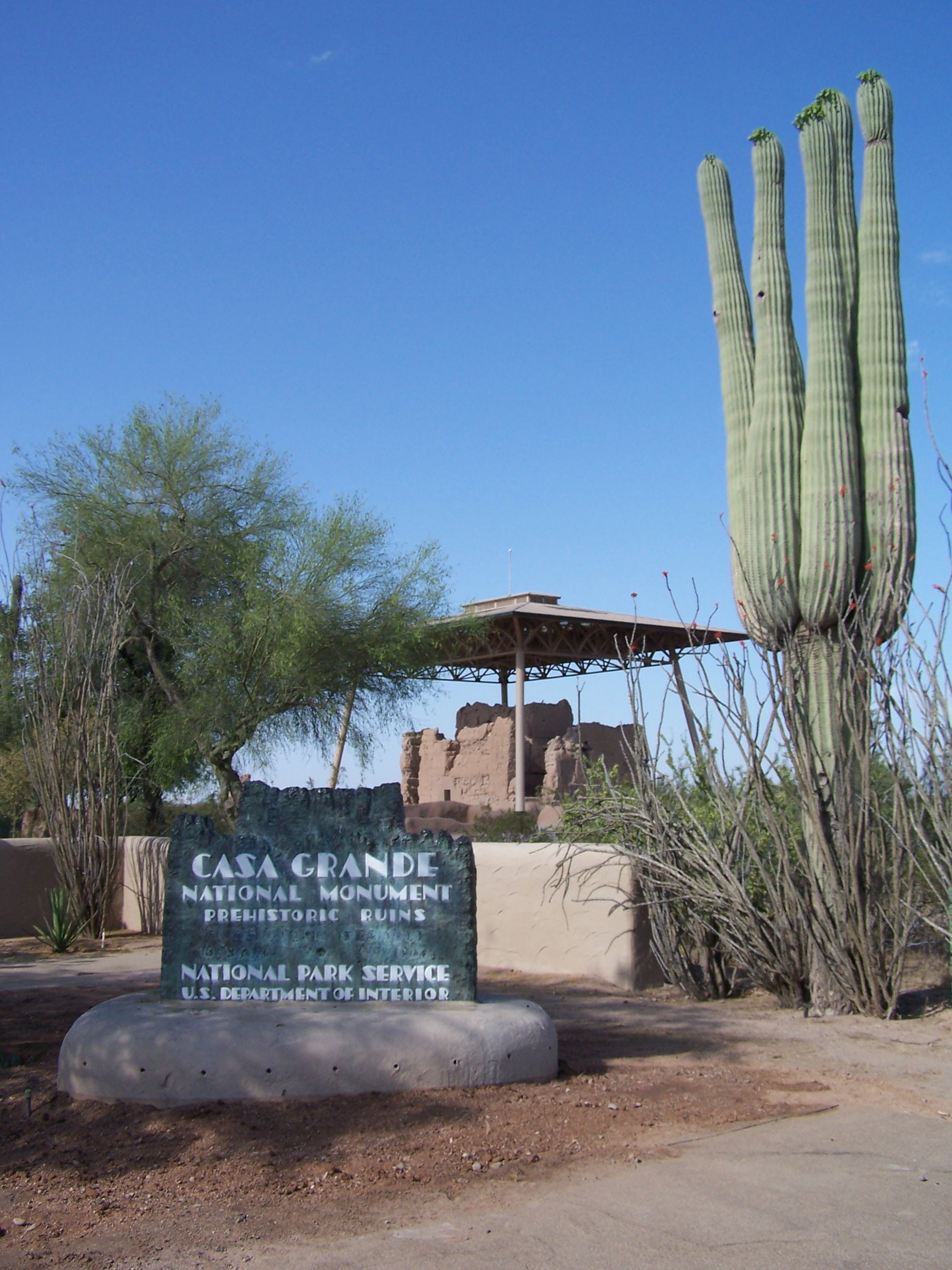 historic copper sign with Great House and saguaro flanking