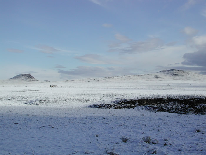 Winter scene of snow covered cinder cones at the Volcanoes Day Use Area.