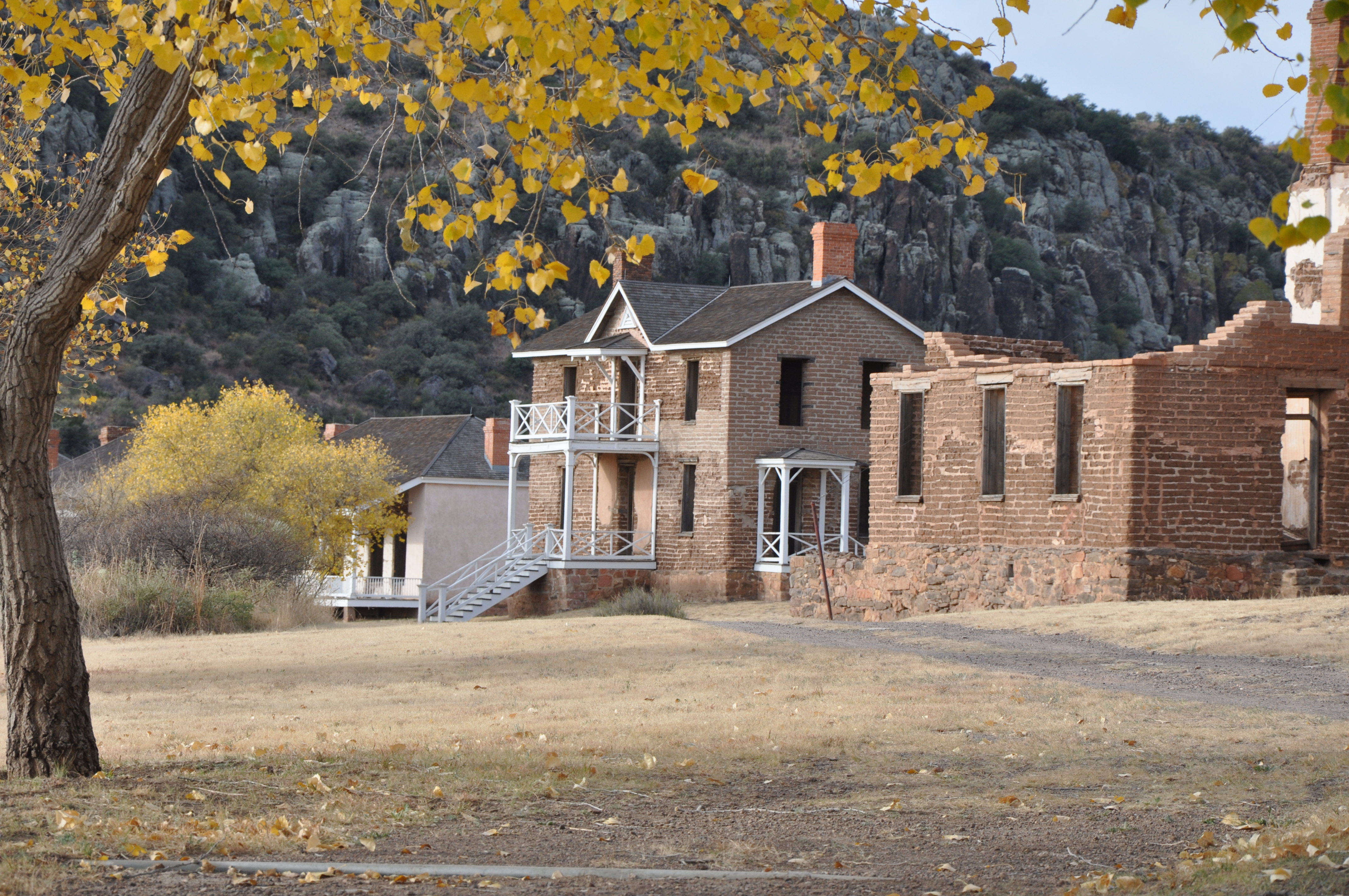 Building and trees at Fort Davis during the fall with yellow leaves.