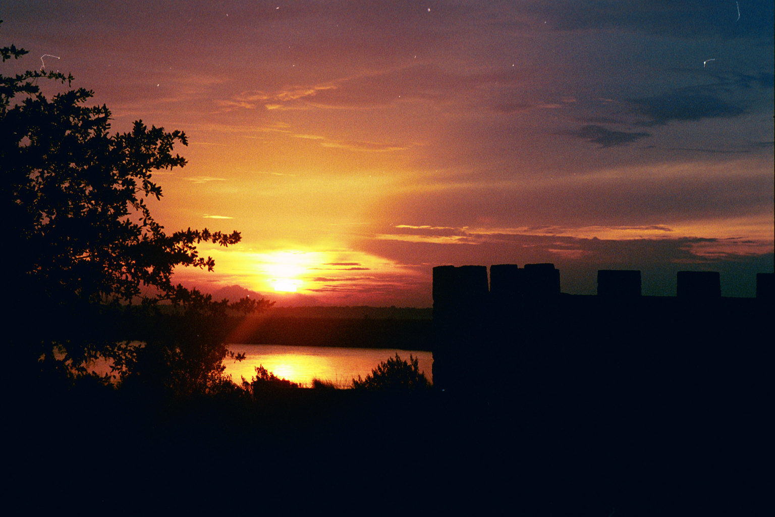 The shadow of the ruin of Fort Frederica highlighted by a sunset along the Frederica River.