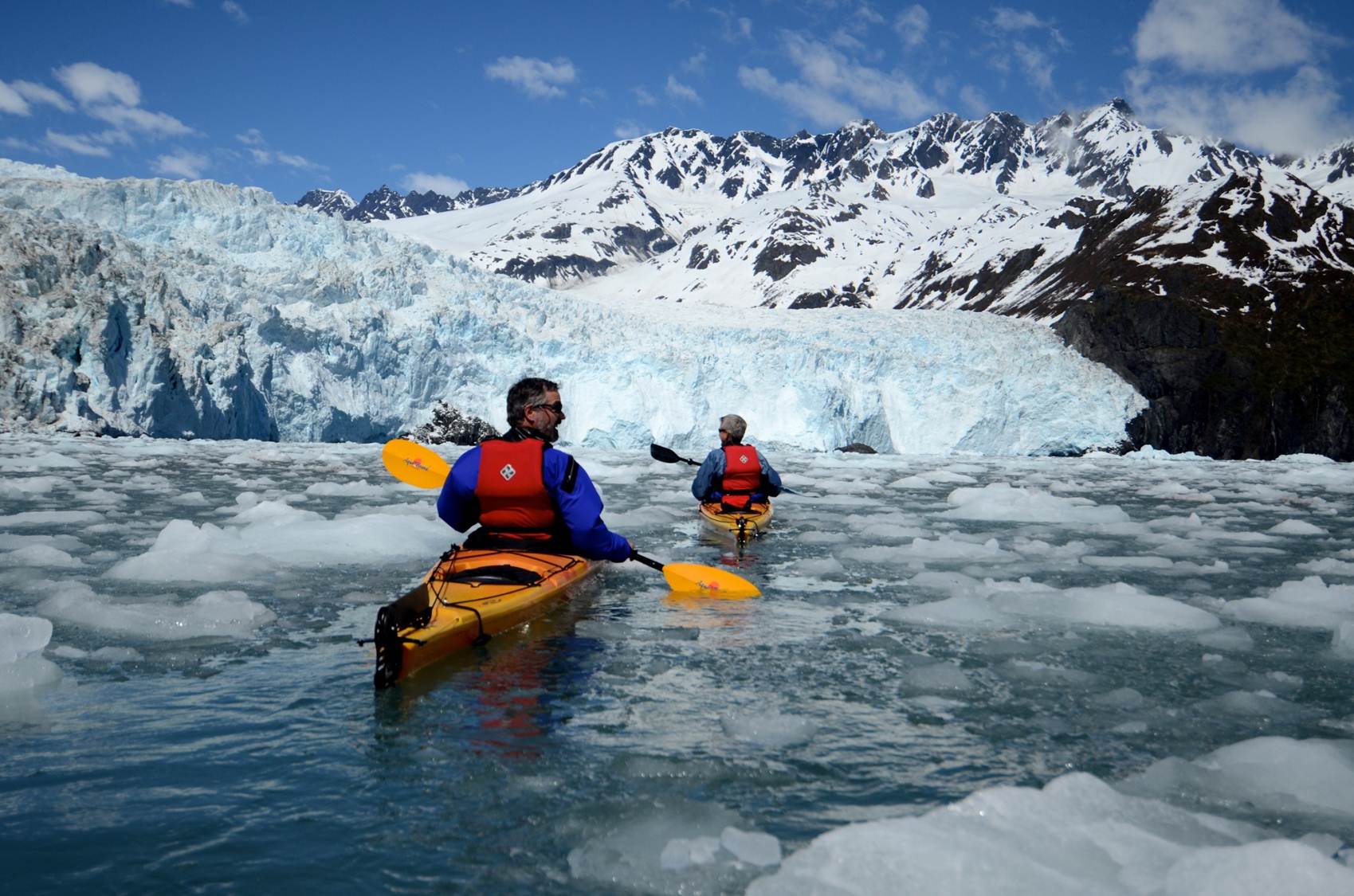 kayakers in front of a tidewater glacier