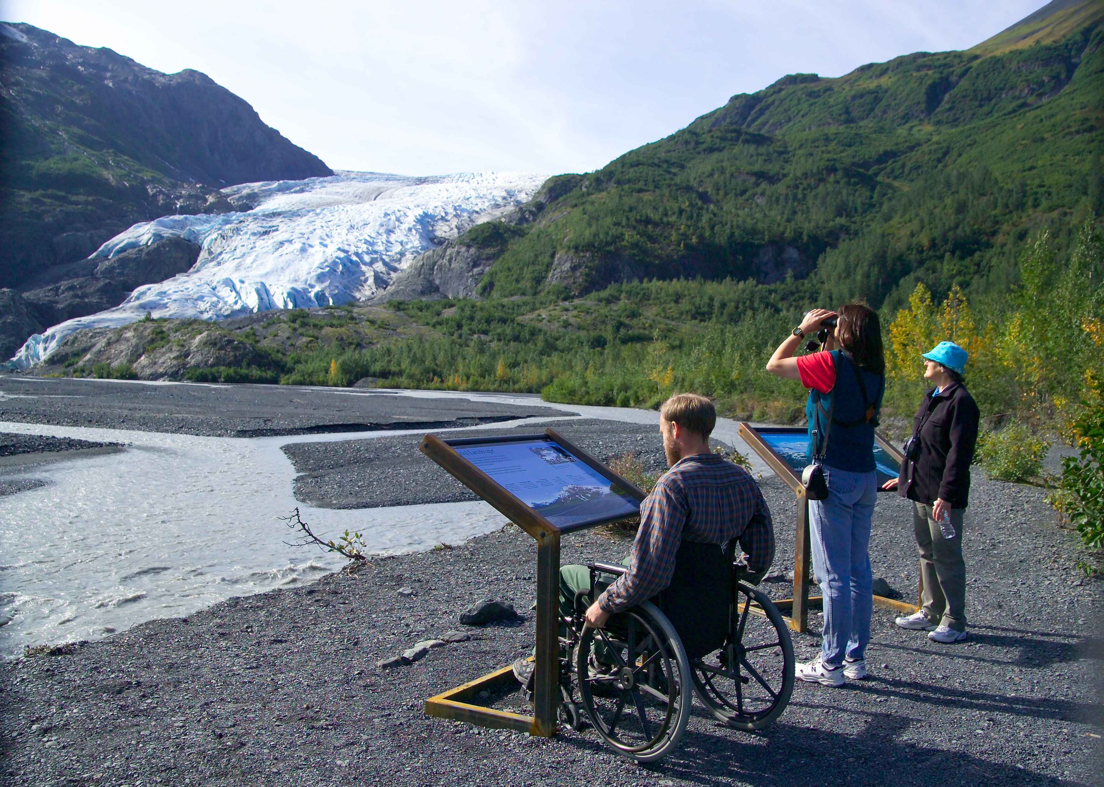 visitors at accessible overlook of Exit Glacier and Exit Creek.