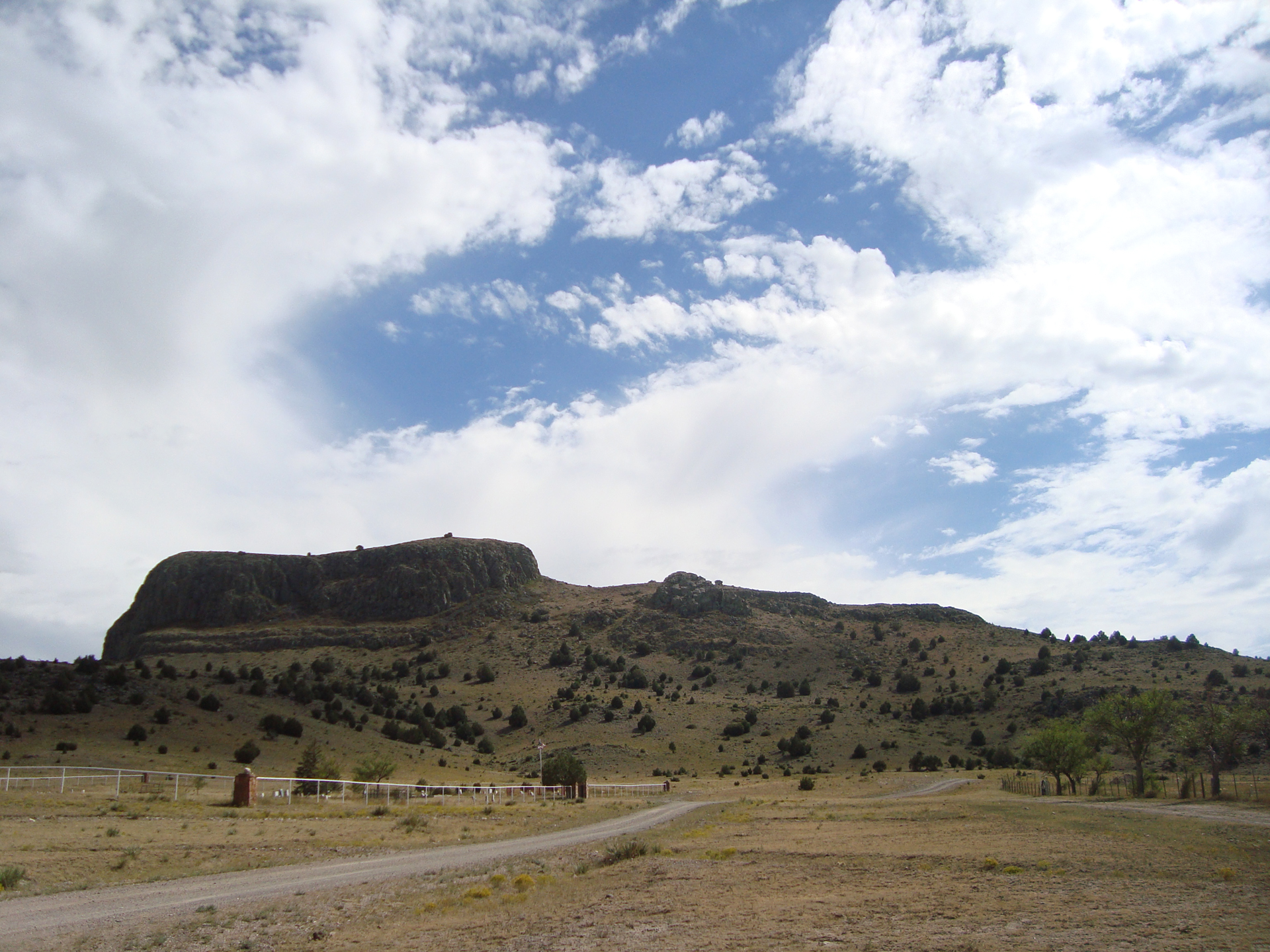 desert landscape with a mountain that looks like a wagon from a distance, verdant green grasses