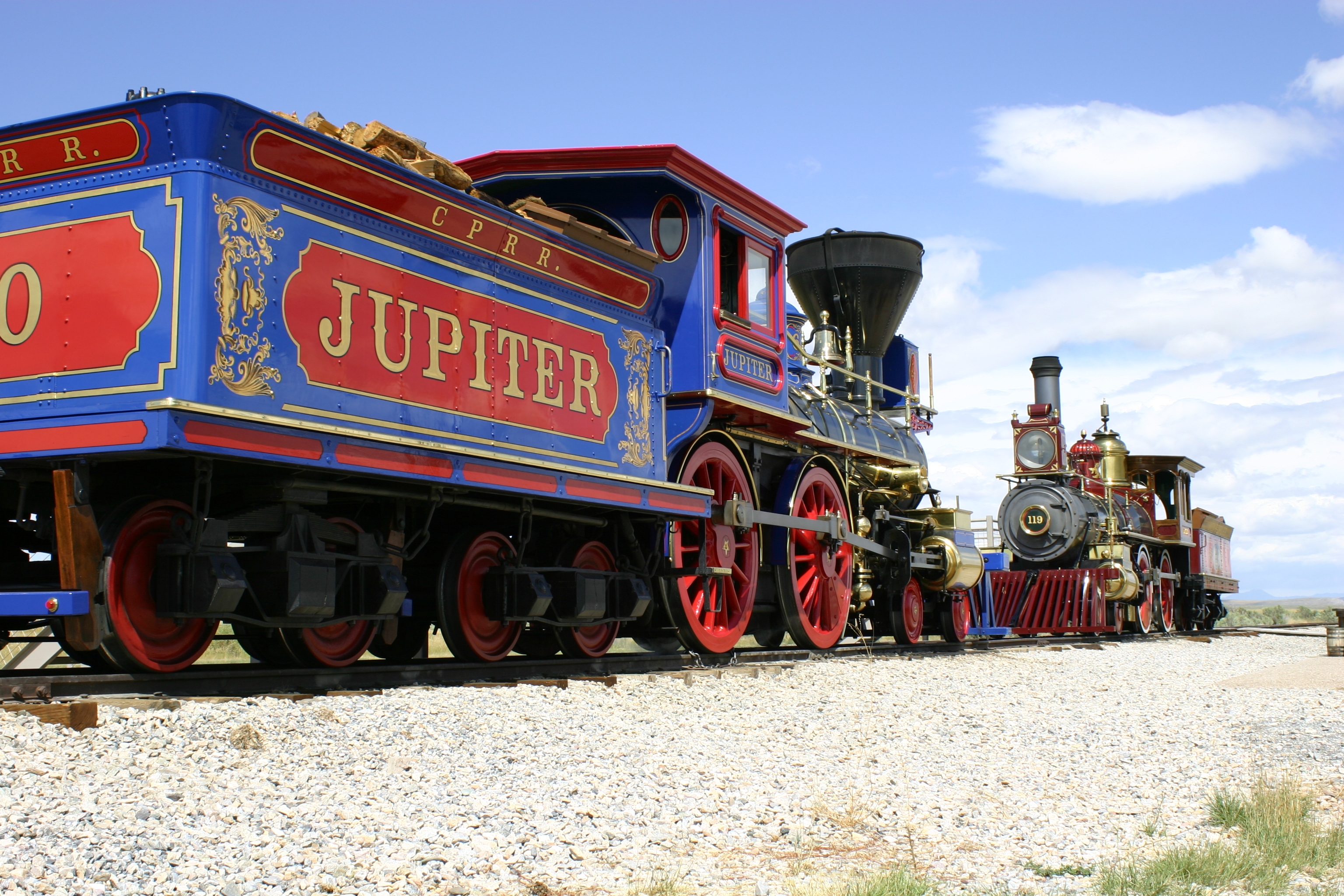 Two replica victorian age steam locomotives face each other on the original railroad grade