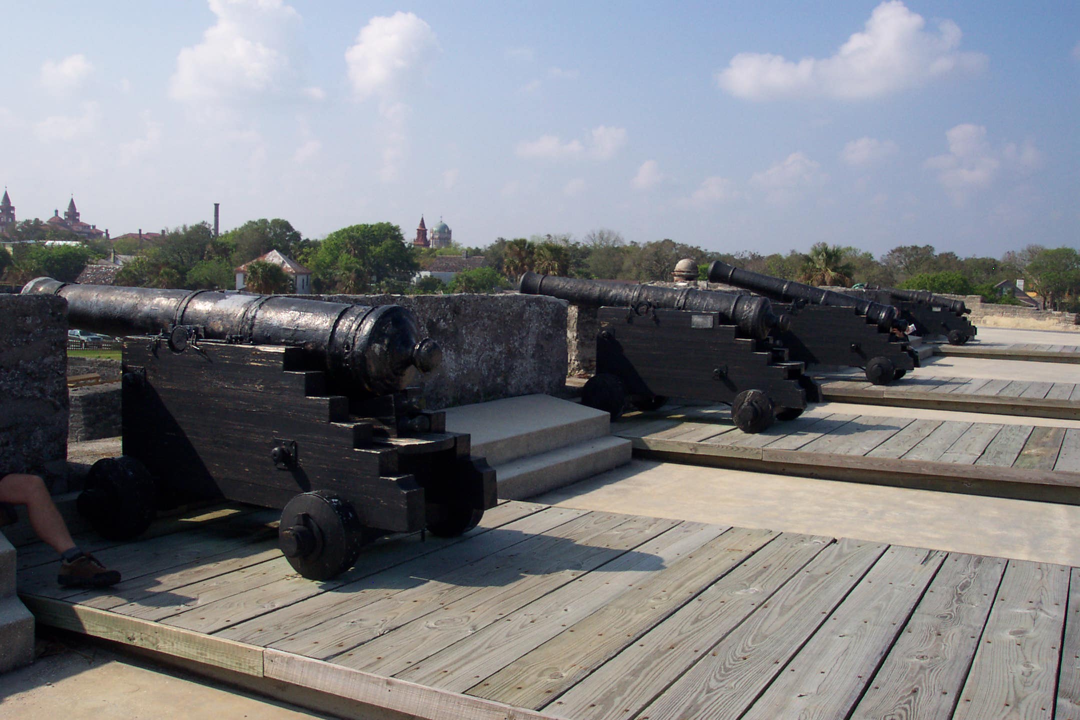 Four black iron cannon mounted on carriages line the walls of the Castillo.