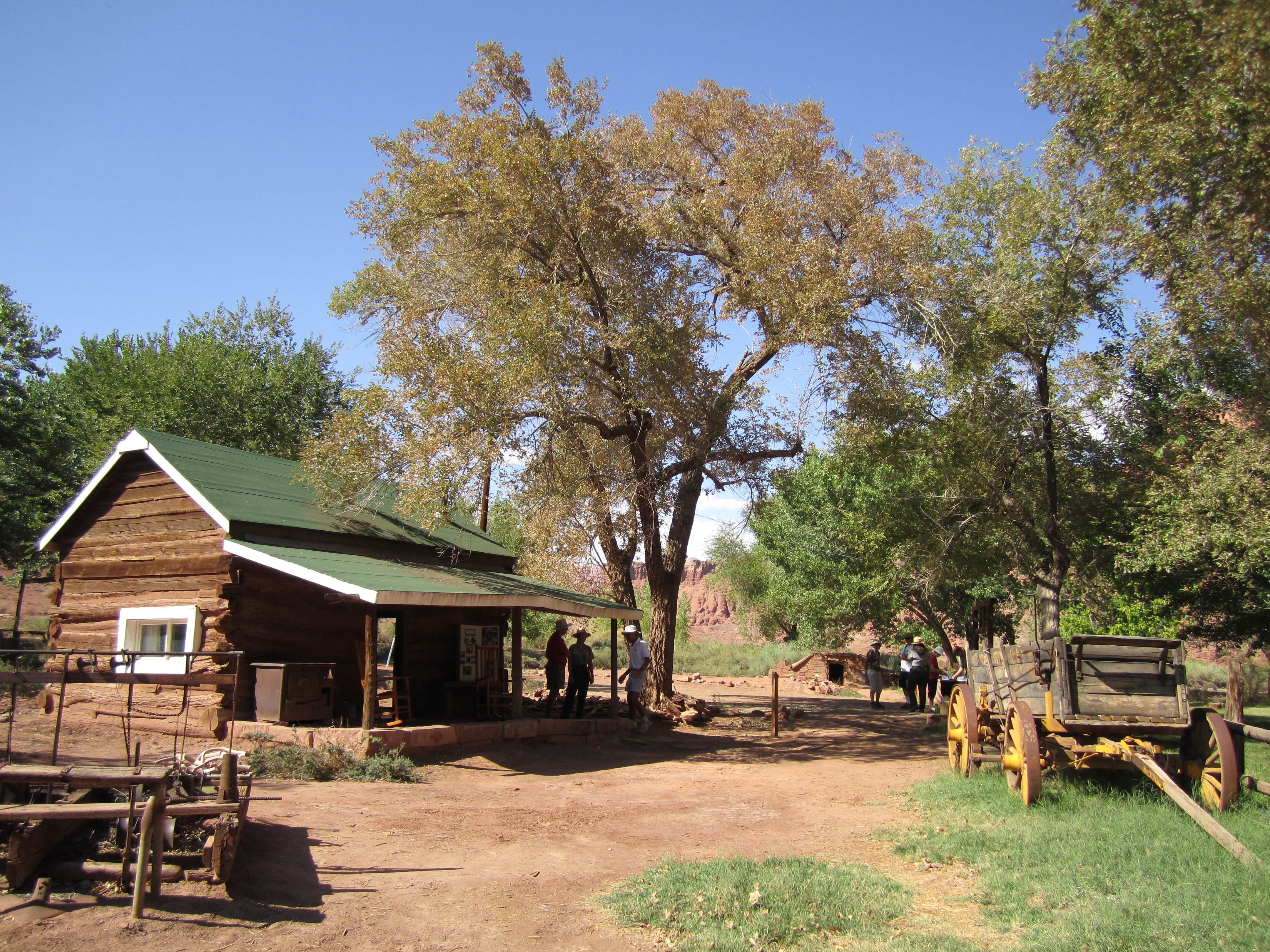 Log cabin and fences with a wooden wagon.