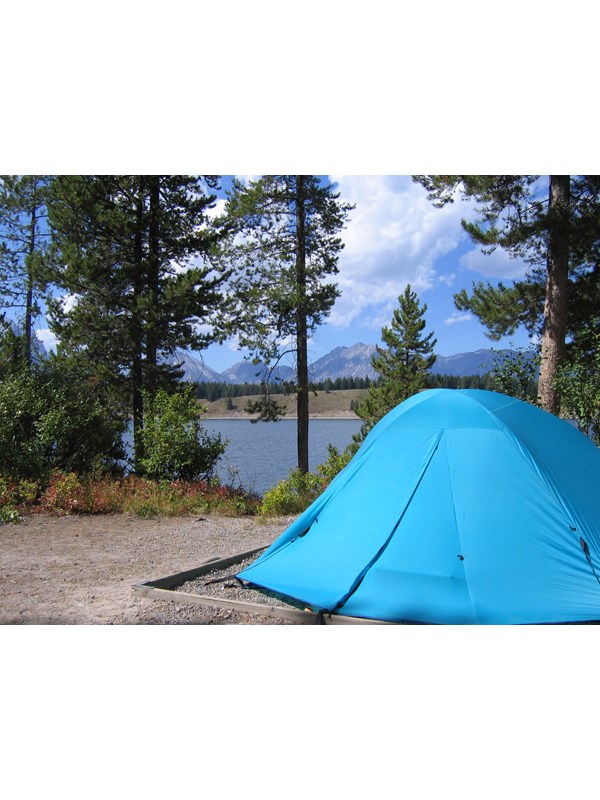 Blue tent with Jackson Lake and the Teton Range in the background