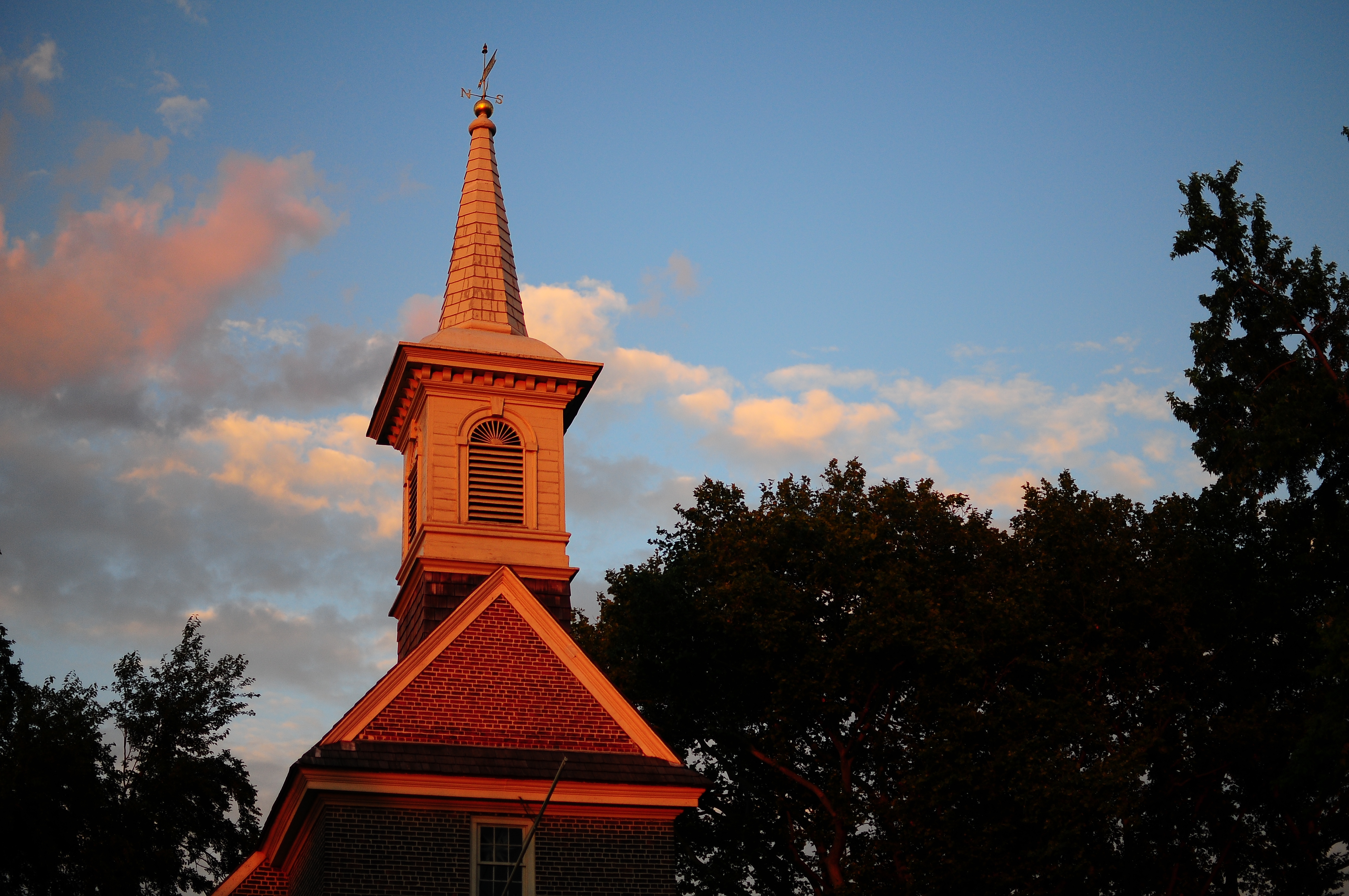 A color photo of the Gloria Dei Church steeple during a sunset in Philadelphia.