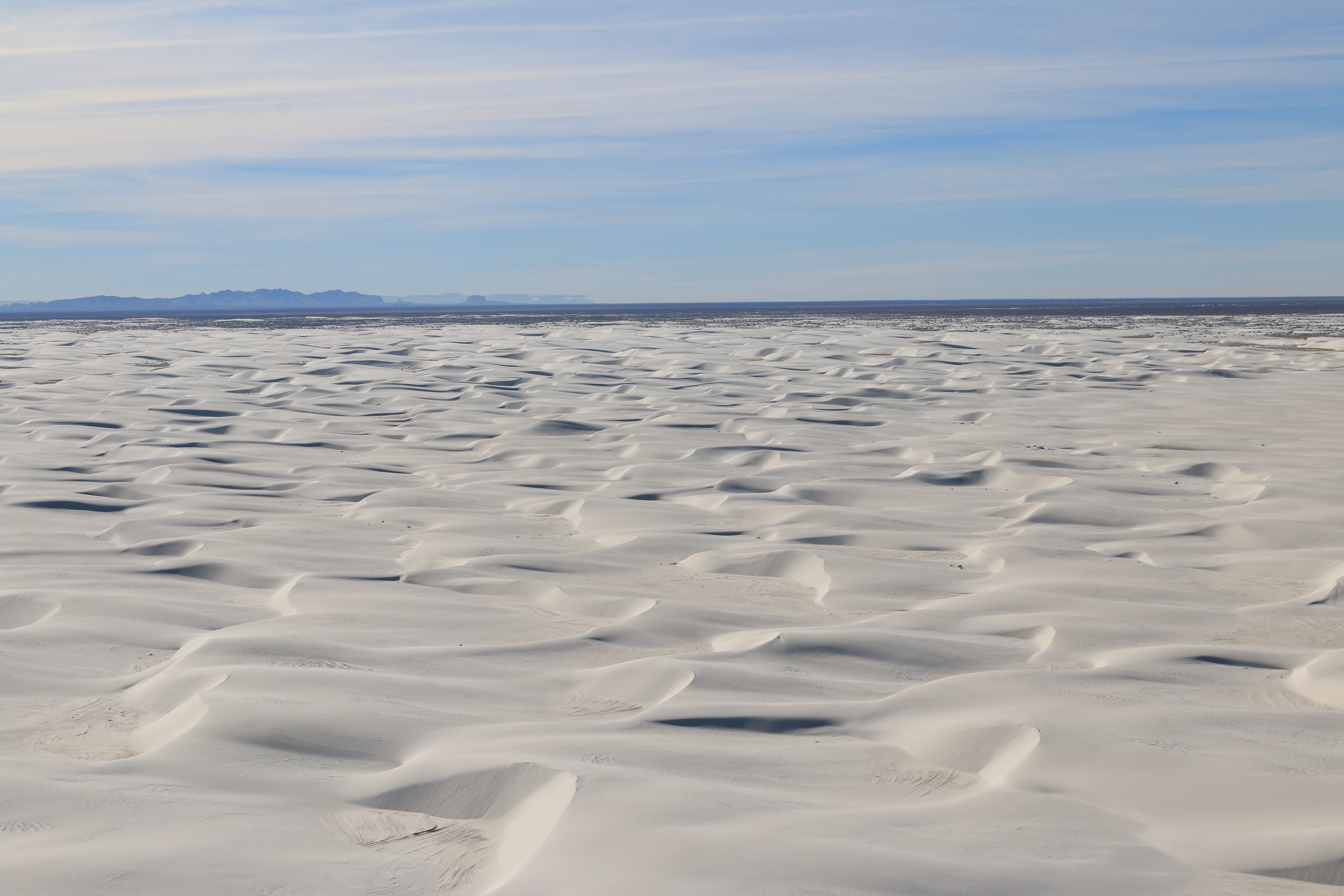 Aerial of white sand dunes.